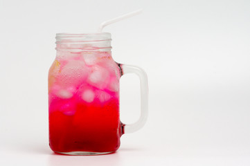 Light red or pink Italian soda in glass bottle isolated on white background, Italian soda is a soft...