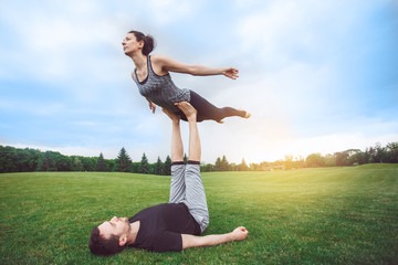 People practice acro yoga outdoors healthy lifestyle
