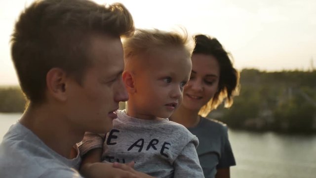 profiles fases of a young happy family with two year old son outdoors
