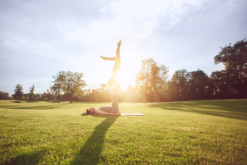 People practice acro yoga outdoors healthy lifestyle