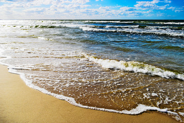 Seascape with waves breaking on the beach. Baltic sea, Pomerania, northern Poland.