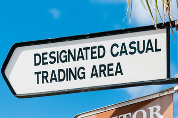 Direction sign for a "Designated Casual Trading Area" for a town market.
