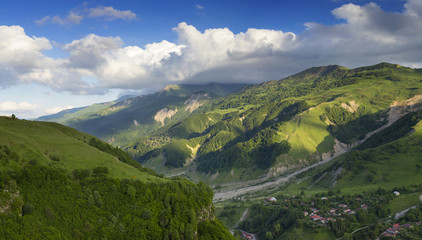 Naklejka premium green valley with sky and clouds in Georgia