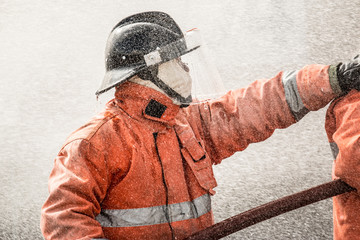 Firefighter searching for possible survivors with tools, tacticle lighting and thermal imaging camera Part of a firefighter series