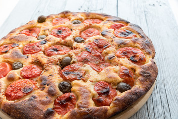 Focaccia typical of Bari Italy with tomatoes and olive