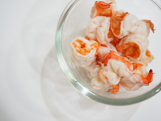 Many boiled red shrimp in glass bowl, white background