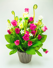 beautiful artificial flowers in ceramic vase