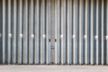 Sliding and folding industrial doors with No Smoking signs