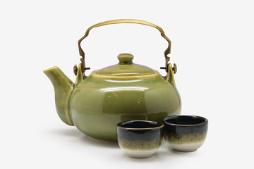 Green Japanese teapot and teacup on white background