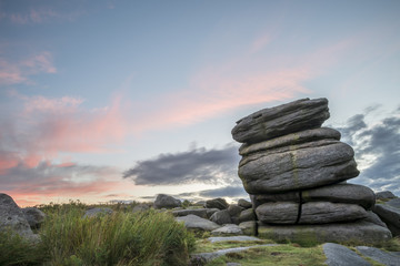 Stunning dawn sunrise landscape image of Higger Tor in Summer in Peak District England