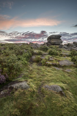 Stunning dawn sunrise landscape image of Higger Tor in Summer in Peak District England