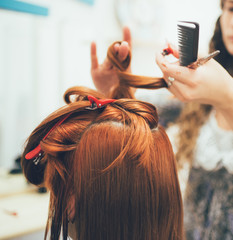 Fototapeta premium Stylist working in the beauty salon, haircut and hair styling