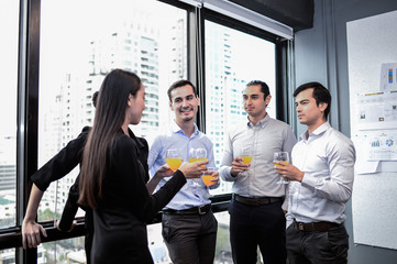 business man are business woman drinking champagne talking and smiling while celebrating in office, successful business concept, vintage style