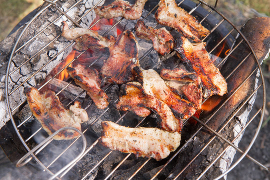 Bacon being grilled, outdoors