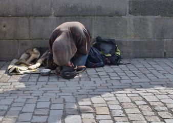 Beggar with his dog on Charlese bridge, Prague, Czech Republic