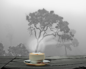 Steaming coffee cup on a rainy day window background