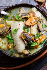 Seafood fish soup in clay bowls served with cold white wine. Top view, copy space
