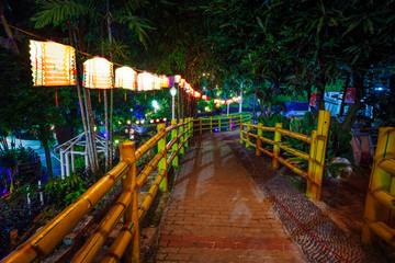 Fototapeta na wymiar Night park decorated with paper lanterns