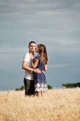 Happy young couple enjoying in the wheat field, summer season