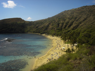 The green mountains, blue waters and beaches as seen from the top of Hanauma Bay in Honolulu, Hawaii.
