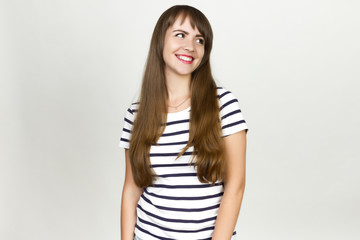Obraz premium Portrait of beautiful smiling young woman .on a gray background