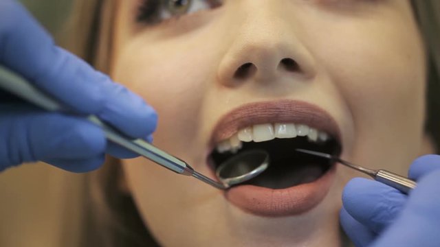 Dentist examining a patient's teeth in the dentistry