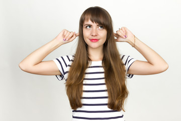 Fototapeta premium Woman putting fingers into her ears