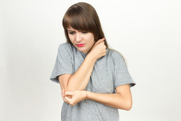 Elbow pain. Beautiful female holding her elbow.