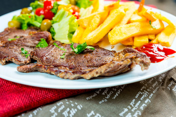 juicy steak beef meat with tomato and french fries