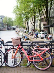 Fototapeta na wymiar Red bicycle on the bridge of Amsterdam