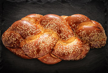 Image of jewish traditional challah bread on slate stone plate