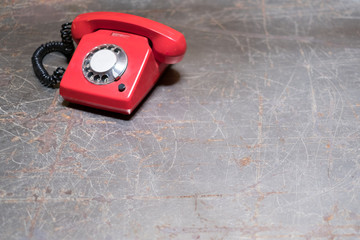 old red phone on table - vintage telephone on desk