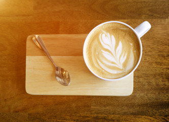Hot latte coffee on wooden table.