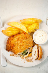 Chicken kiev with basil pesto, potato chips and mayo dip