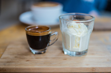 Affogato coffee or espresso with ice cream on wood texture and blurred background