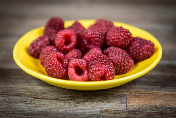 Healthy raspberry fresh organic fruit on a wooden table in vintage style