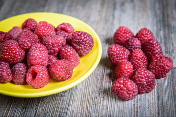 Healthy raspberry fresh organic fruit on a wooden table in vintage style