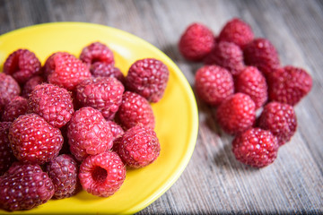 Healthy raspberry fresh organic fruit on a wooden table in vintage style