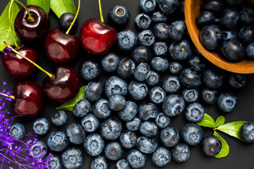 Assorted fresh berries on a wooden background
