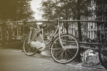 Bicycle on Bridge in Amsterdam Netherlands, sepia and black and white toned and with selective foreground focus