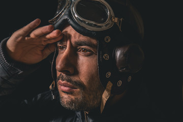 Portrait of a man with aviator helmet and goggles looking into the distance