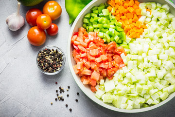 Vegetable saute in a pan and ingredients. Top view.