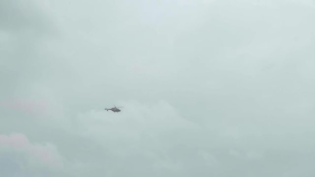 Helicopter flying in the sky. Left to right view