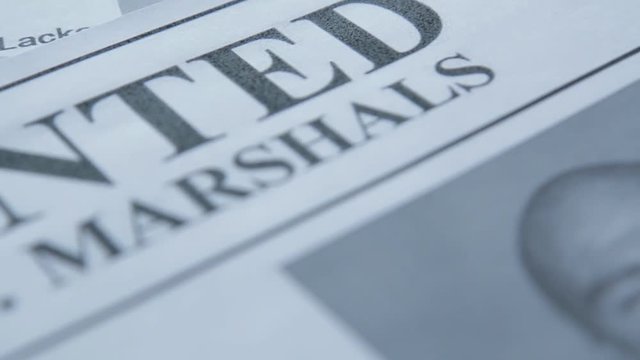 An announcement about the search for a criminal on the table of the bounty hunter, a combat pistol, cartridges