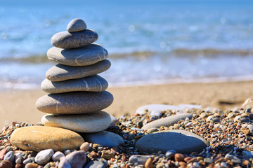 Spa stones balance on beach.
