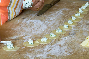 woman put stuffed in italian pasta, tortelli