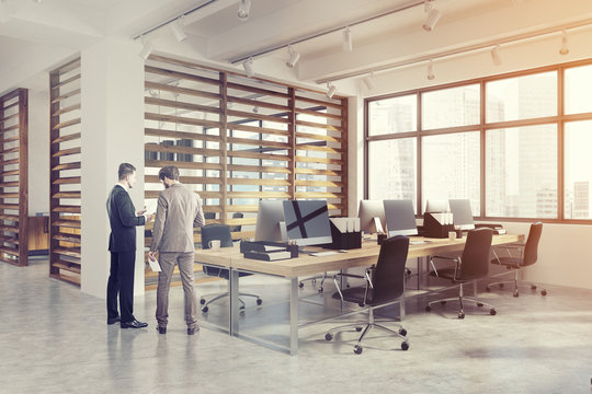 Open office interior with plank walls, men