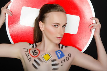 Portrait of young beautiful woman with traffic signs