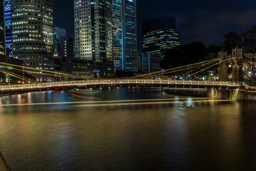 Old brightly illuminated bridge on the Singapore river at sunset  - 5
