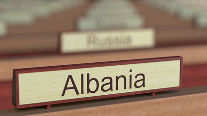 Albania name sign among different countries plaques at international organization. 3D rendering